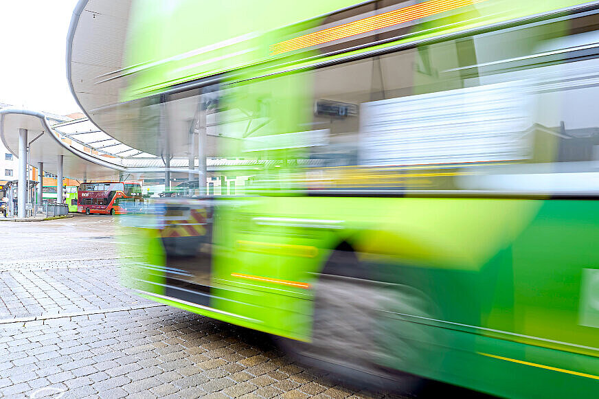 ein fahrender grünfarbener Reisebus